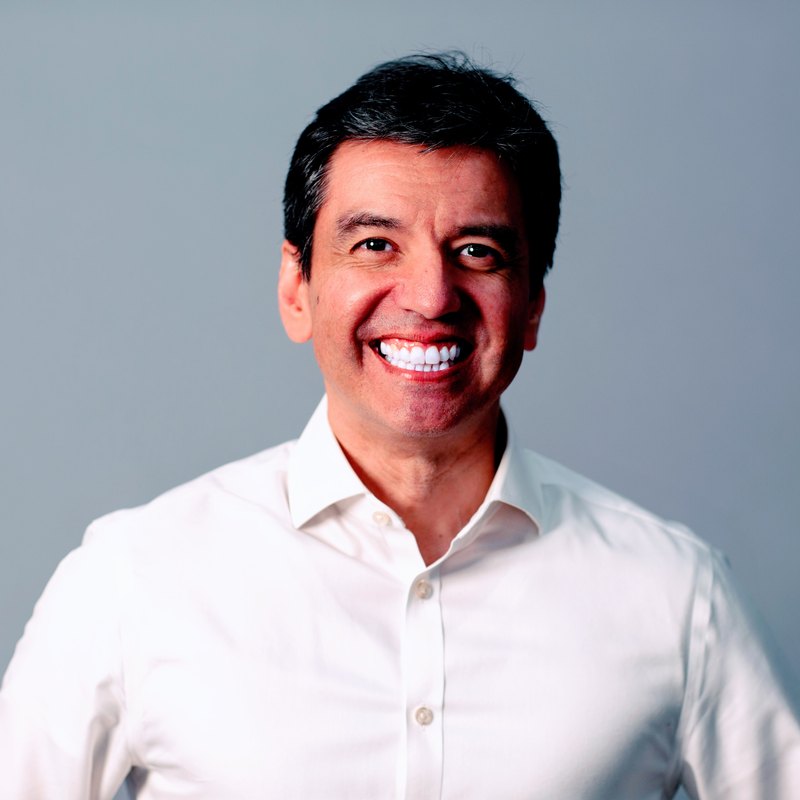 Dennis González, a professional head-and-shoulders portrait.